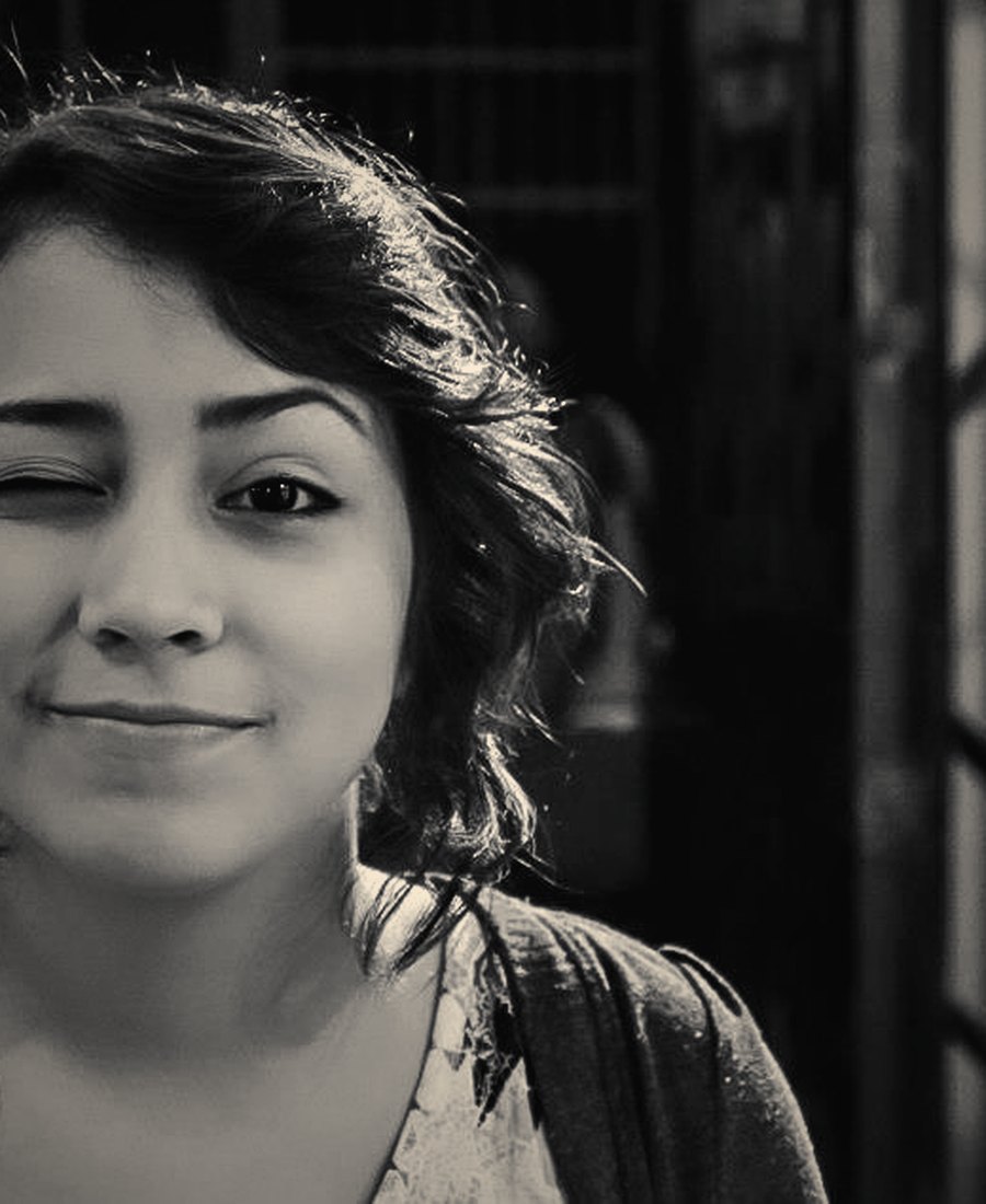 A black-and-white portrait of a young woman smiling